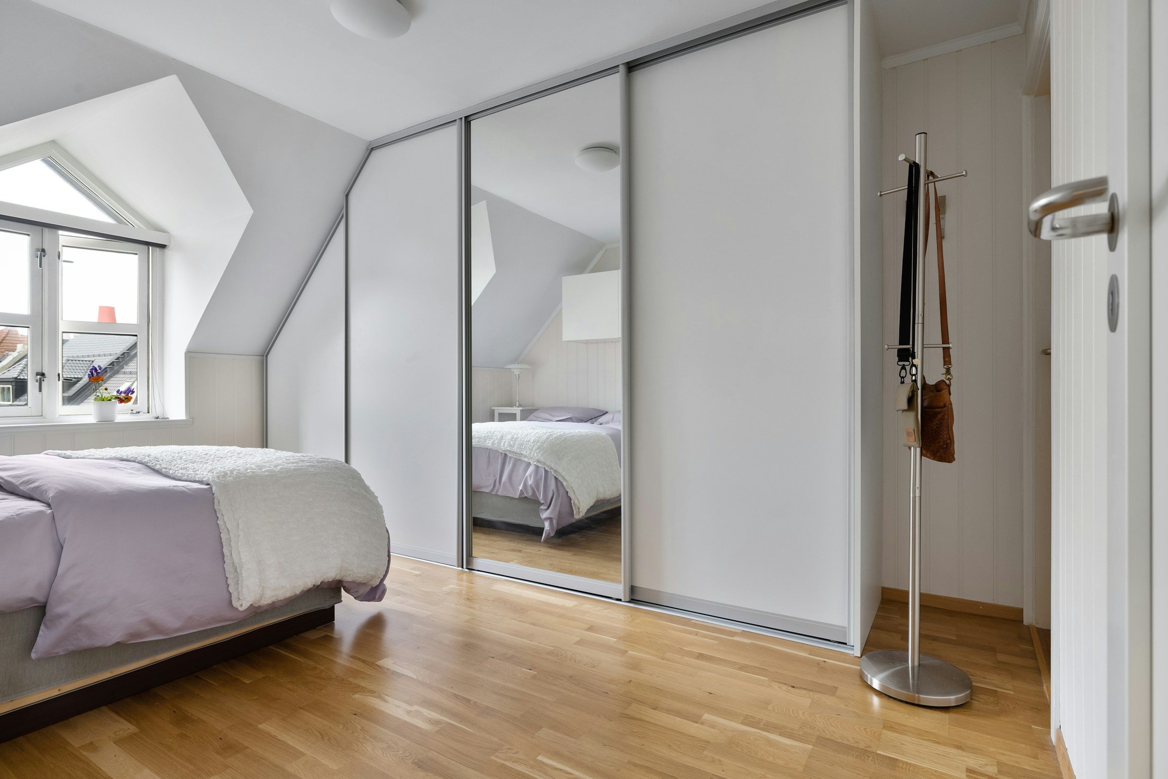 White fitted wardrobe under a sloping ceiling, example image