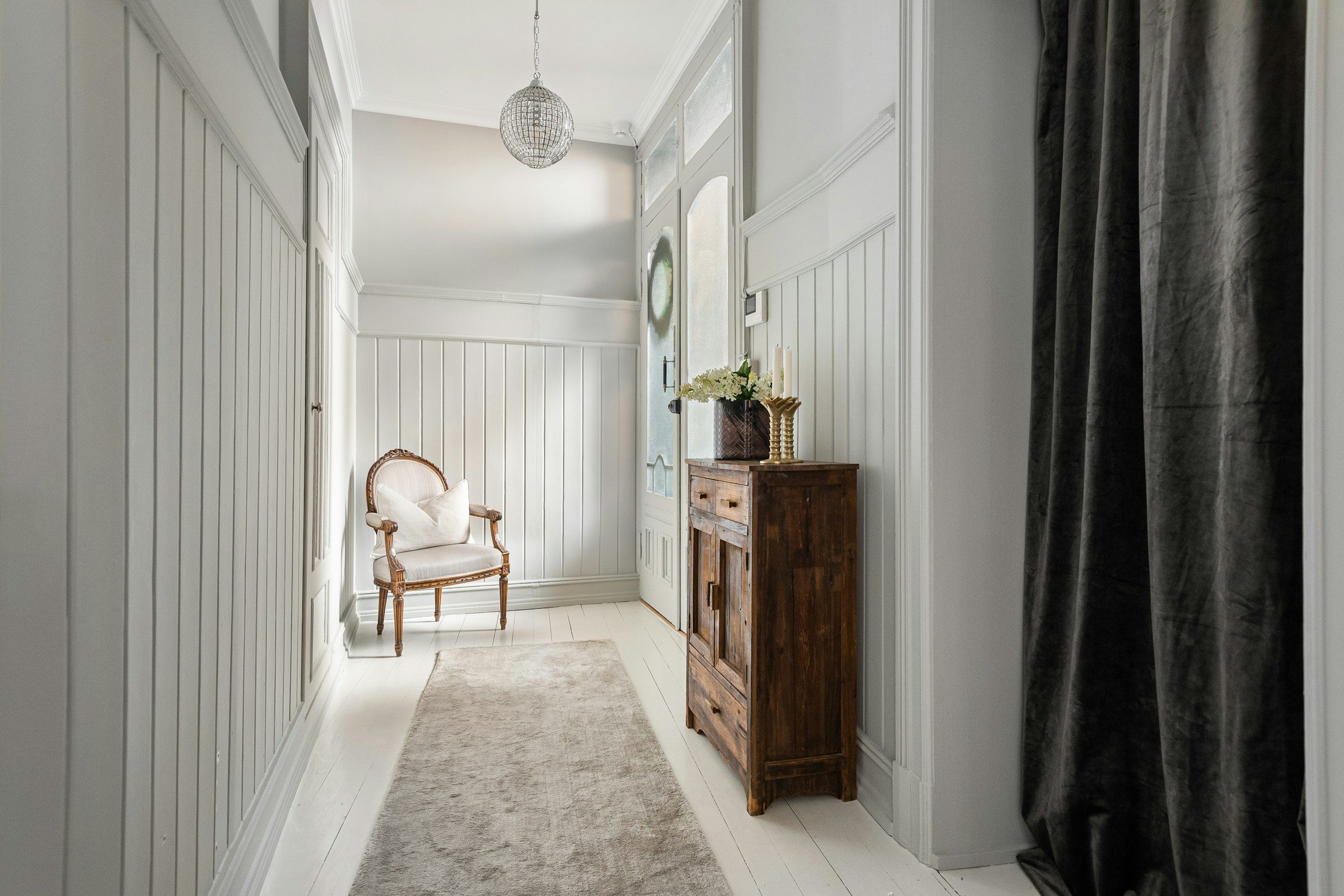 Painted wall panelling in a hallway, example image