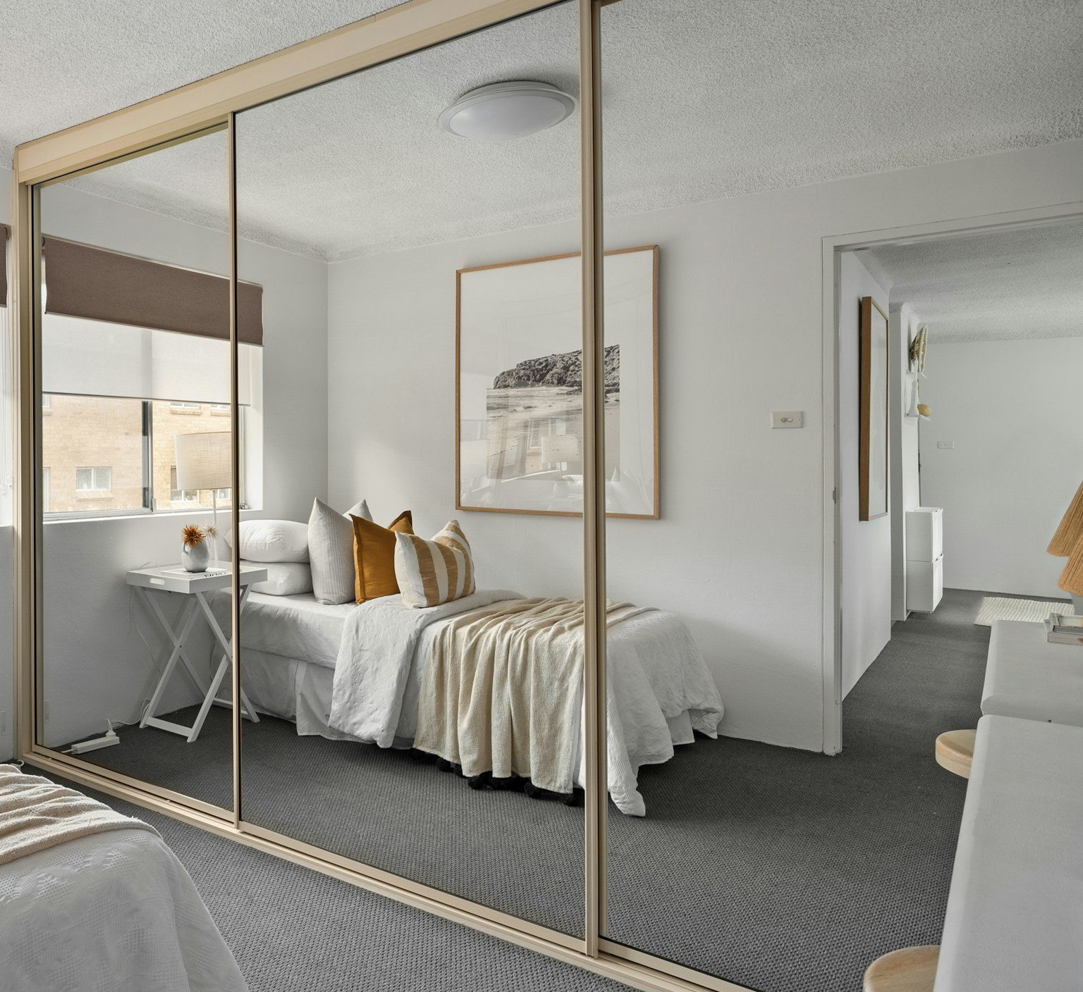 Sliding doors with mirror panels and brass frames, example image