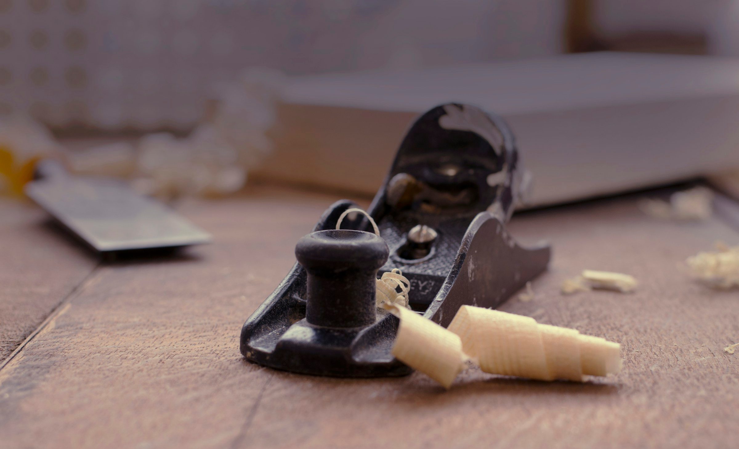 Hand plane and wood shavings on a workbench, example image